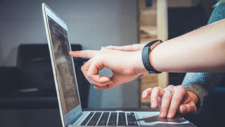 hands working on a laptop