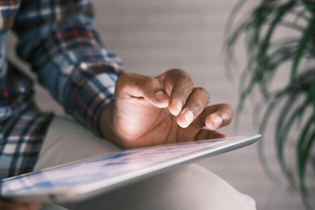 close up of hand using a tablet