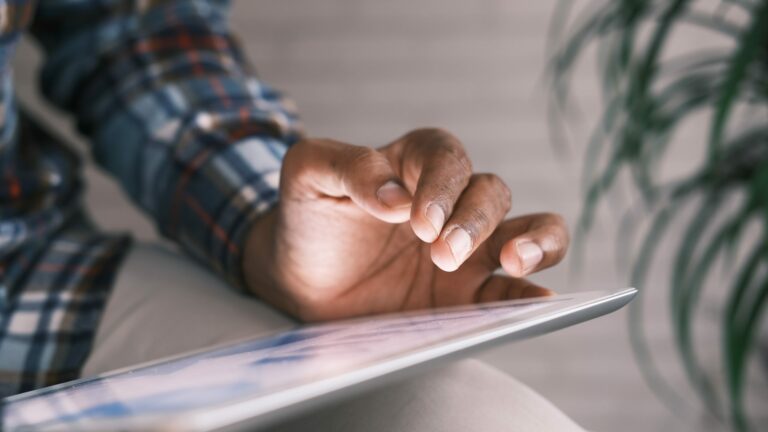 close up of hand using a tablet