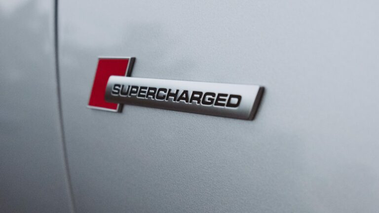 Supercharged badge on grey background